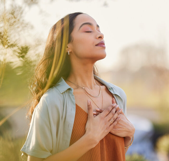 woman with hands over her heart in gratitude