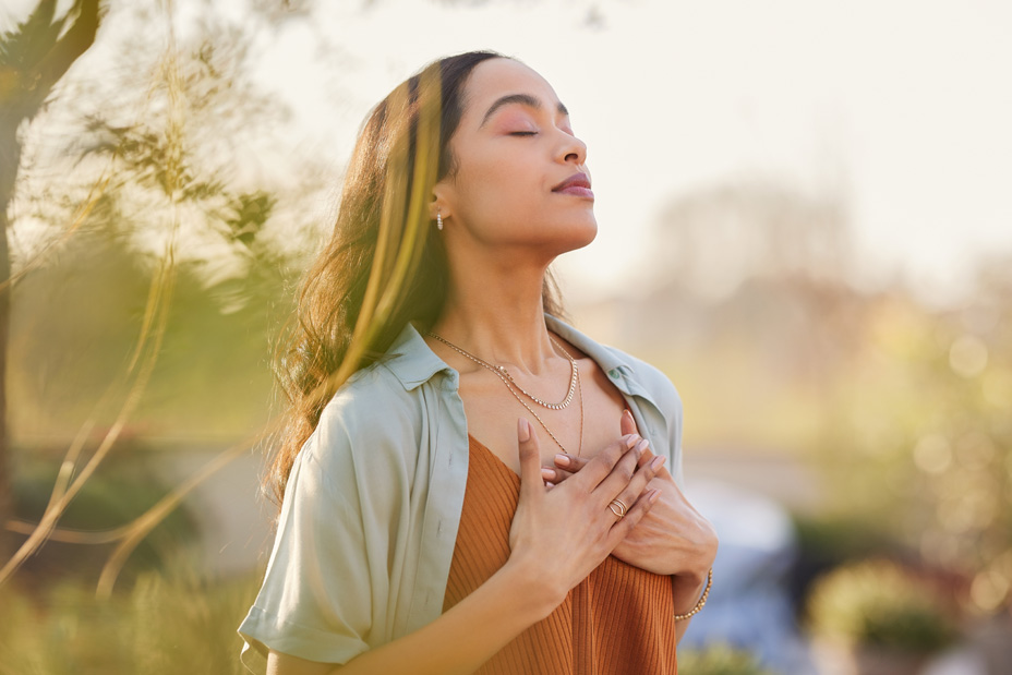 woman with hands over her heart in gratitude