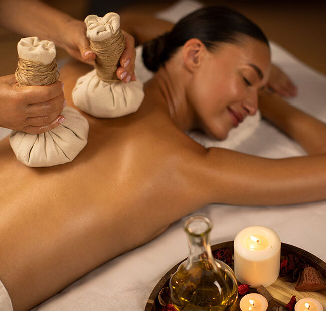 A woman receives an Ayurveda massage treatment.