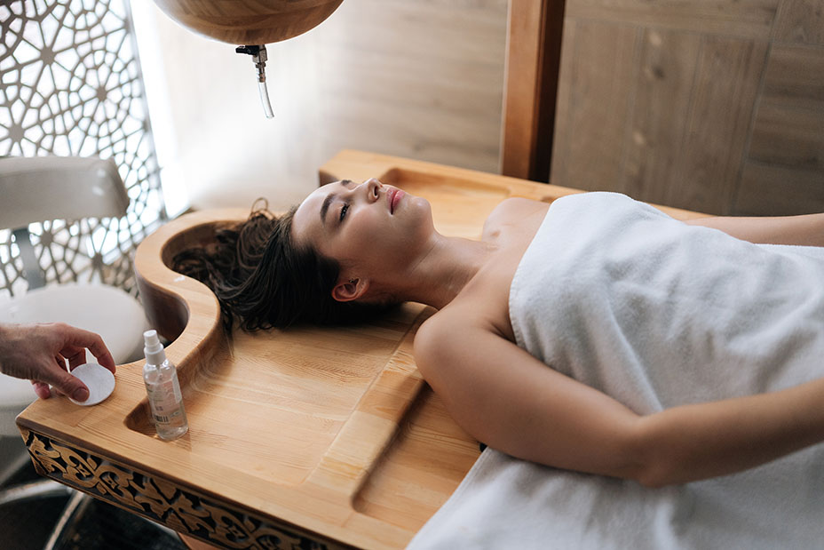 A relaxed woman lays supine and waits for a massage.