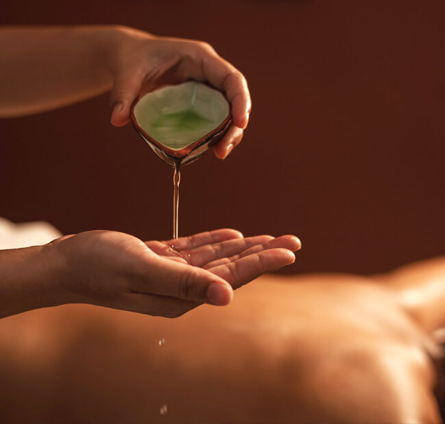 woman pouring oil into her hands to begin the Ayurvedic detox