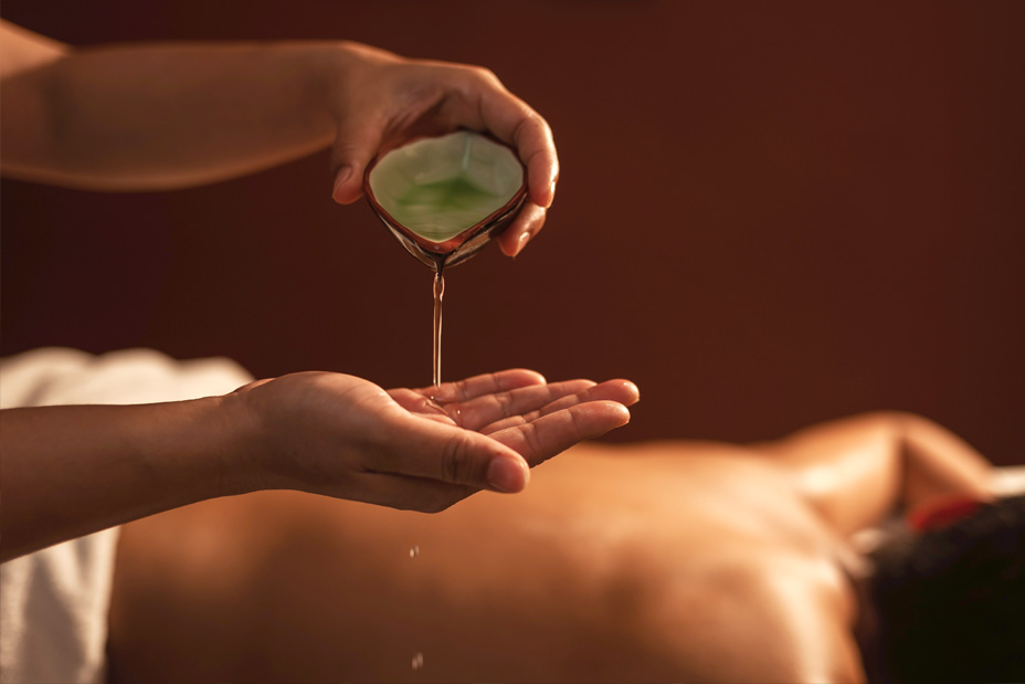 woman pouring oil into her hands to begin the Ayurvedic detox