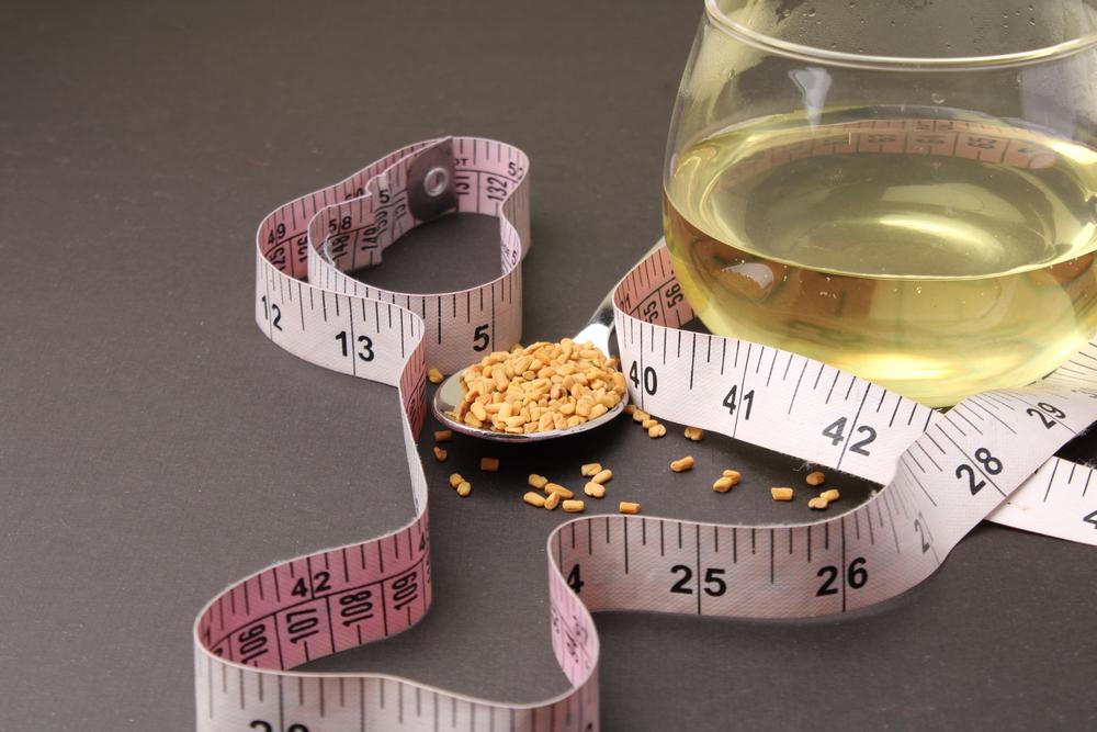 Fenugreek seeds around a tape measure