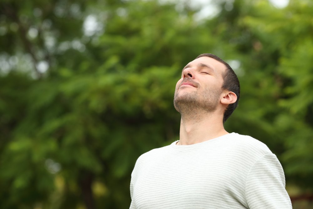 A contented man sits with nature in the springtime.
