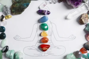 Drawing of a person with colored gemstones placed over the chakras.