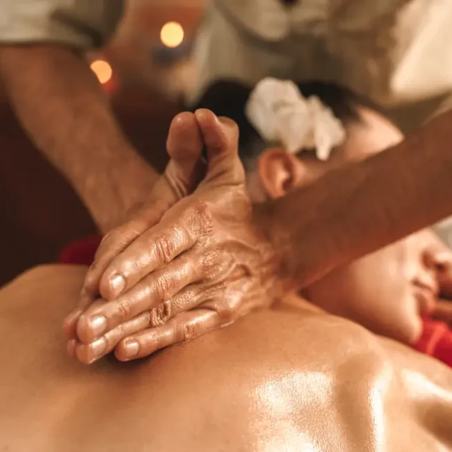 A close-up photo of a woman receiving an Abhyanga Ayurvedic massage.