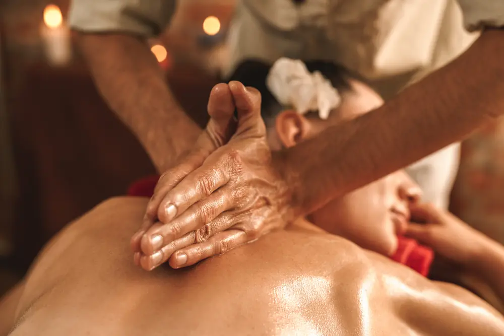 A close-up photo of a woman receiving an Abhyanga Ayurvedic massage.