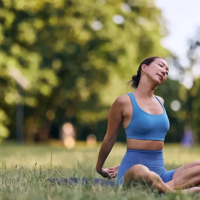 A woman practicing outdoor yoga for alignment with nature in the morning.